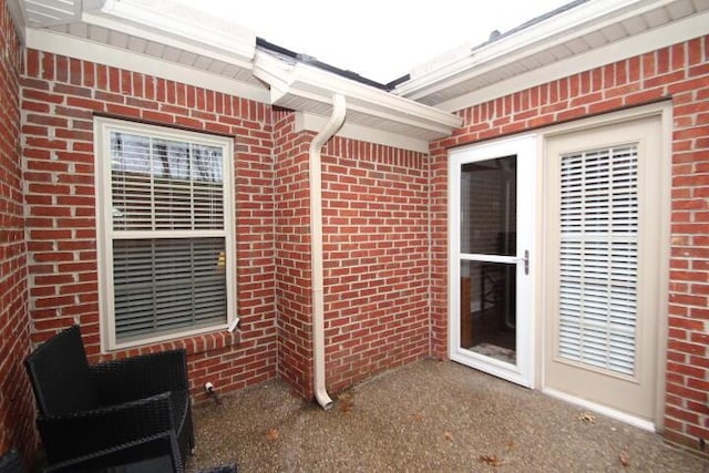 property entrance with brick siding