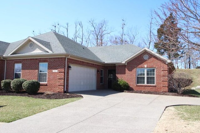 single story home with an attached garage, roof with shingles, concrete driveway, and brick siding