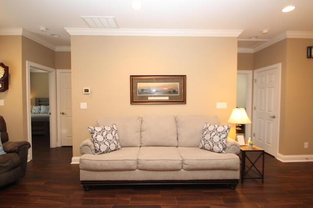 living area featuring visible vents, crown molding, baseboards, and wood finished floors