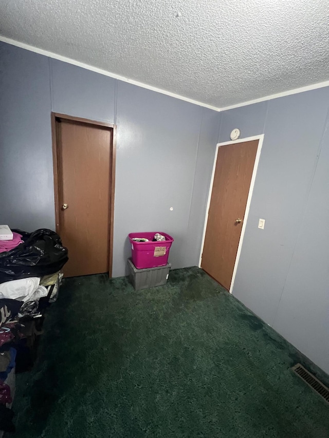 interior space with visible vents, a textured ceiling, and carpet flooring