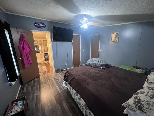 bedroom with ornamental molding, ceiling fan, a textured ceiling, and wood finished floors