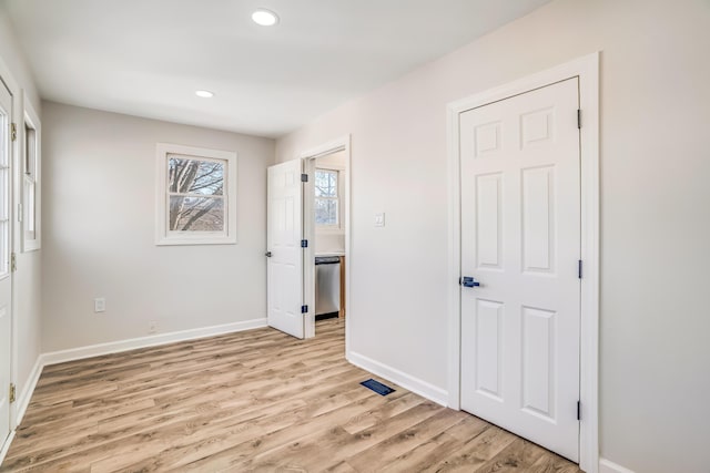 unfurnished bedroom featuring light wood finished floors, baseboards, and recessed lighting