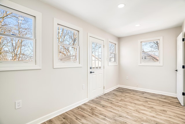 entrance foyer with light wood finished floors, baseboards, and recessed lighting