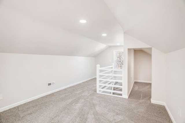 bonus room featuring lofted ceiling, carpet flooring, baseboards, and recessed lighting