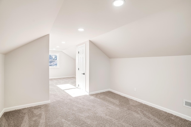 additional living space with lofted ceiling, baseboards, carpet flooring, and recessed lighting