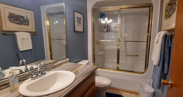 bathroom with enclosed tub / shower combo, tile patterned flooring, vanity, and toilet