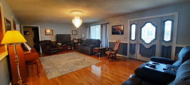 living room featuring a notable chandelier and wood finished floors