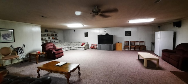 living area with carpet flooring, visible vents, and a ceiling fan