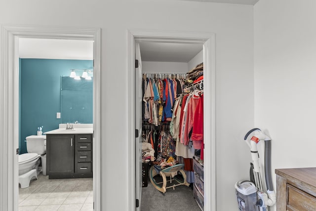 interior space with light tile patterned floors and a sink