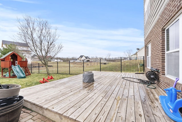 deck with a yard, a playground, and a fenced backyard