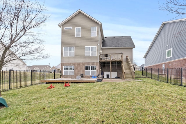 rear view of property with a deck, a yard, and a fenced backyard