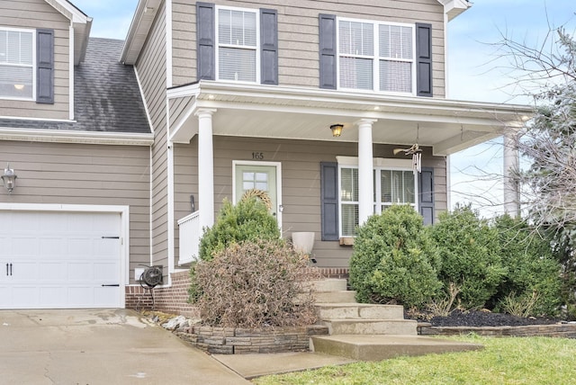 view of front of property with a porch, roof with shingles, driveway, and brick siding