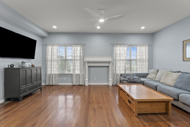 living room featuring recessed lighting, a fireplace, a ceiling fan, baseboards, and hardwood / wood-style floors