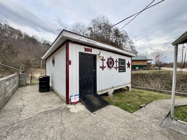 view of outbuilding with an outdoor structure and fence