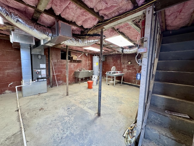 unfinished basement featuring water heater and heating unit