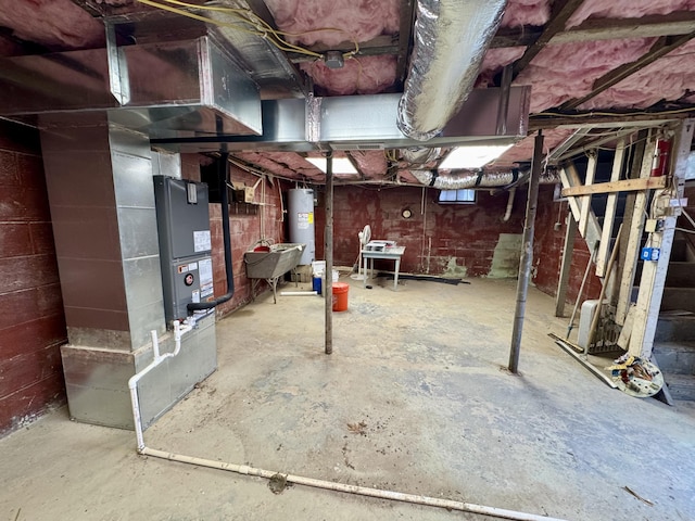 unfinished basement with water heater, a sink, and heating unit