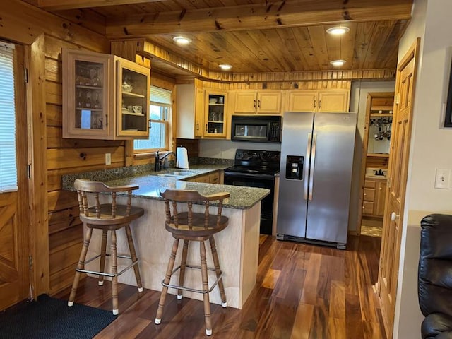 kitchen featuring wooden ceiling, dark wood-style flooring, a peninsula, black appliances, and a sink