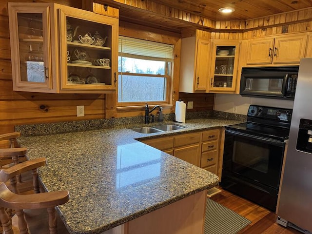 kitchen featuring wooden ceiling, dark wood-style flooring, a peninsula, black appliances, and a sink