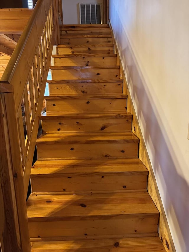 staircase featuring visible vents