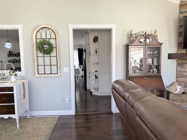 living area featuring dark wood finished floors and baseboards