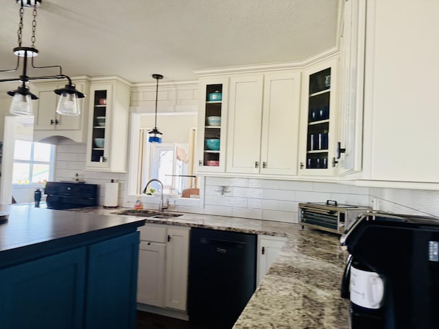 kitchen featuring backsplash, dishwasher, hanging light fixtures, white cabinets, and a sink