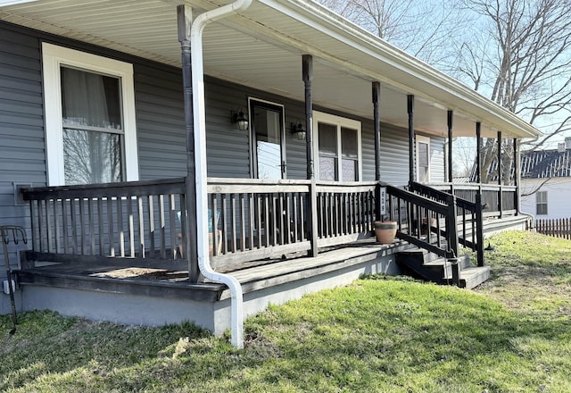 view of exterior entry featuring covered porch