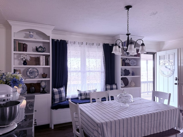 dining area featuring a textured ceiling, an inviting chandelier, dark wood-style flooring, and crown molding