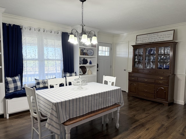 dining area with dark wood-style floors, a notable chandelier, and crown molding