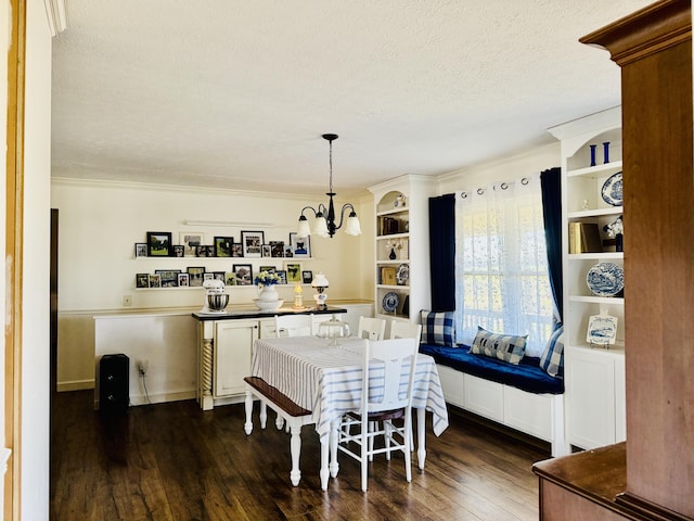 dining space featuring dark wood finished floors, a notable chandelier, a textured ceiling, and crown molding