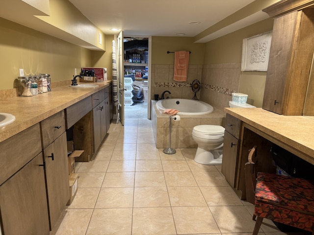 bathroom featuring tile patterned floors, toilet, a sink, double vanity, and a bath