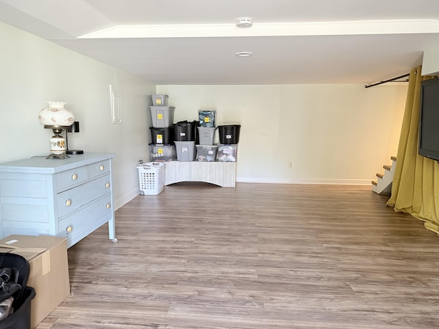 home office with light wood-style flooring and baseboards