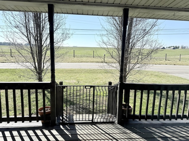 deck featuring a yard and a rural view