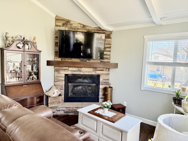 living area with a fireplace, crown molding, wood finished floors, and baseboards