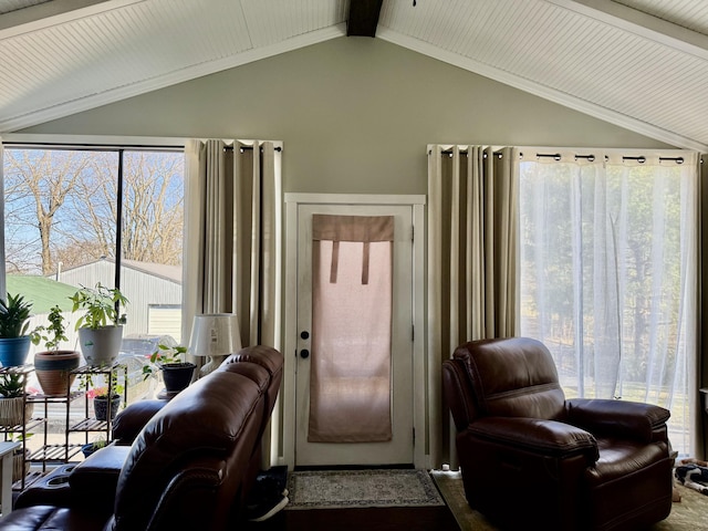 living area featuring lofted ceiling with beams