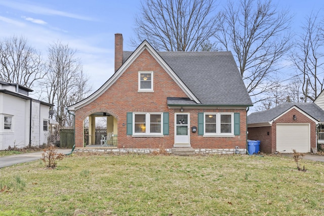 view of front of home with a front yard, a shingled roof, a chimney, and brick siding