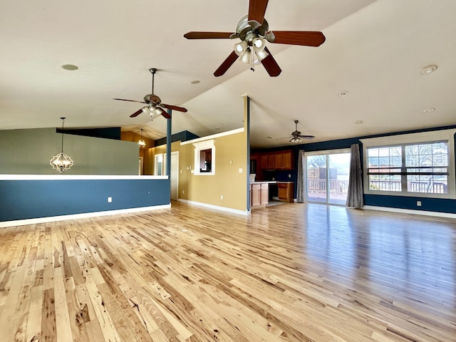 unfurnished living room featuring vaulted ceiling, light wood-type flooring, a chandelier, and baseboards