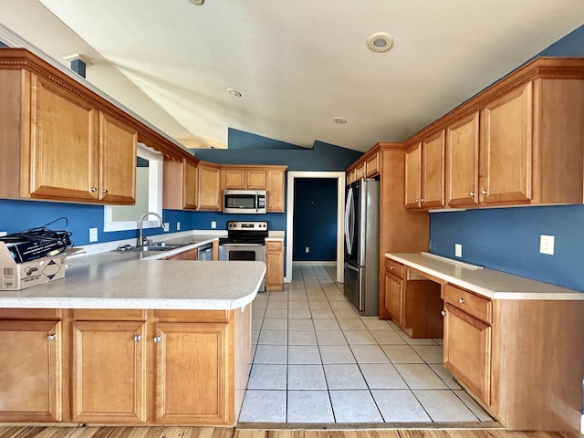 kitchen with stainless steel appliances, a peninsula, a sink, light countertops, and built in study area