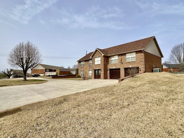 view of side of home featuring brick siding, a yard, central air condition unit, concrete driveway, and an attached garage