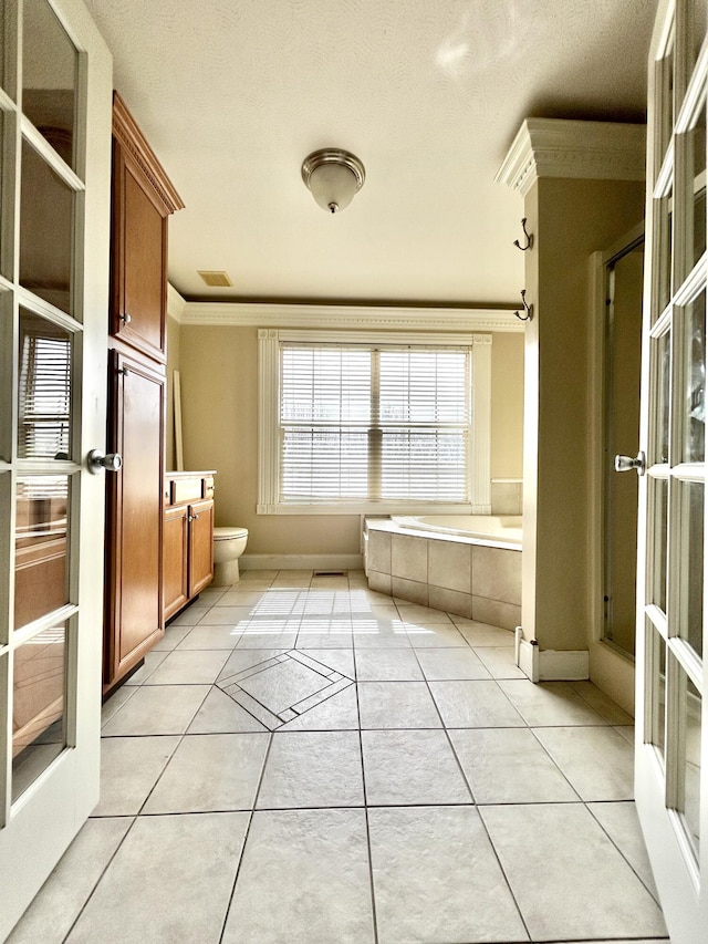 full bath featuring a stall shower, visible vents, toilet, tile patterned flooring, and crown molding