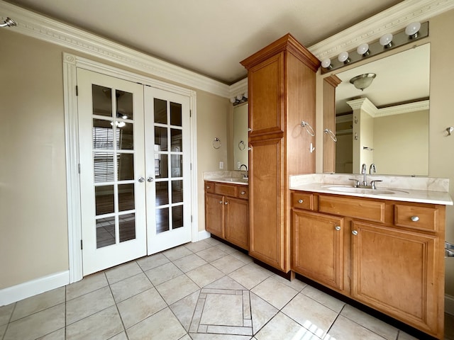 full bath with baseboards, french doors, tile patterned flooring, crown molding, and vanity