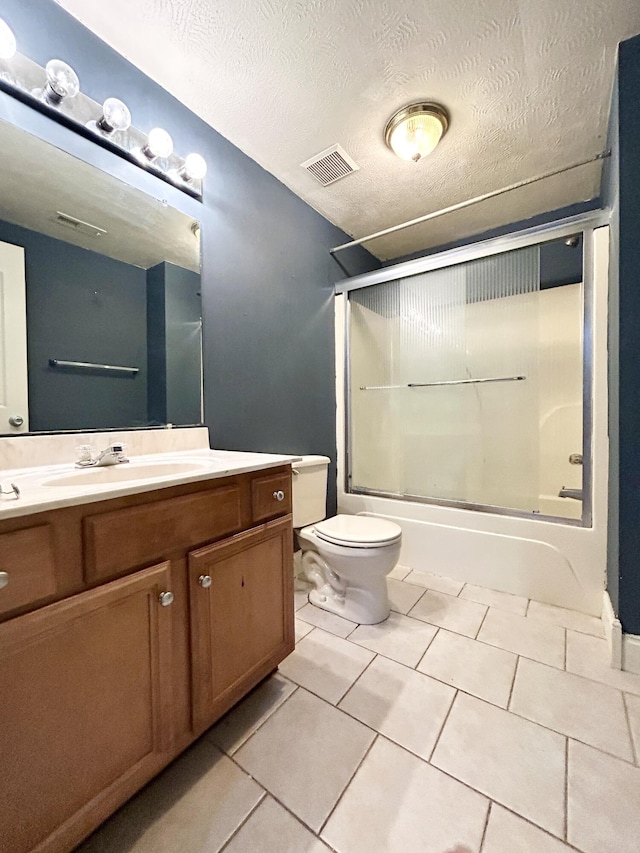 bathroom featuring enclosed tub / shower combo, tile patterned flooring, toilet, vanity, and visible vents