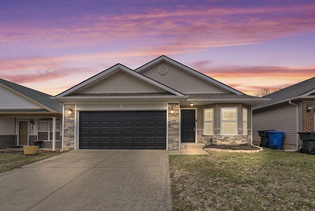 view of front of home with concrete driveway, a front lawn, an attached garage, and stone siding