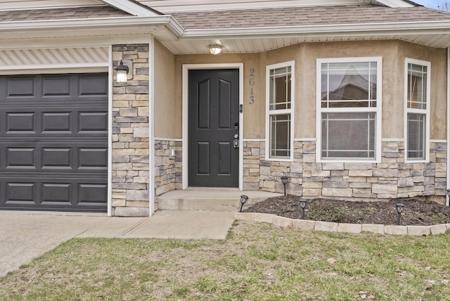 doorway to property with stone siding, a shingled roof, an attached garage, and stucco siding