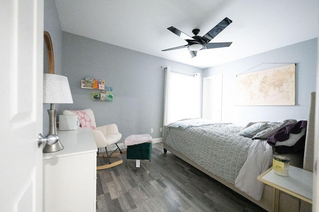 bedroom with ceiling fan, baseboards, and wood finished floors