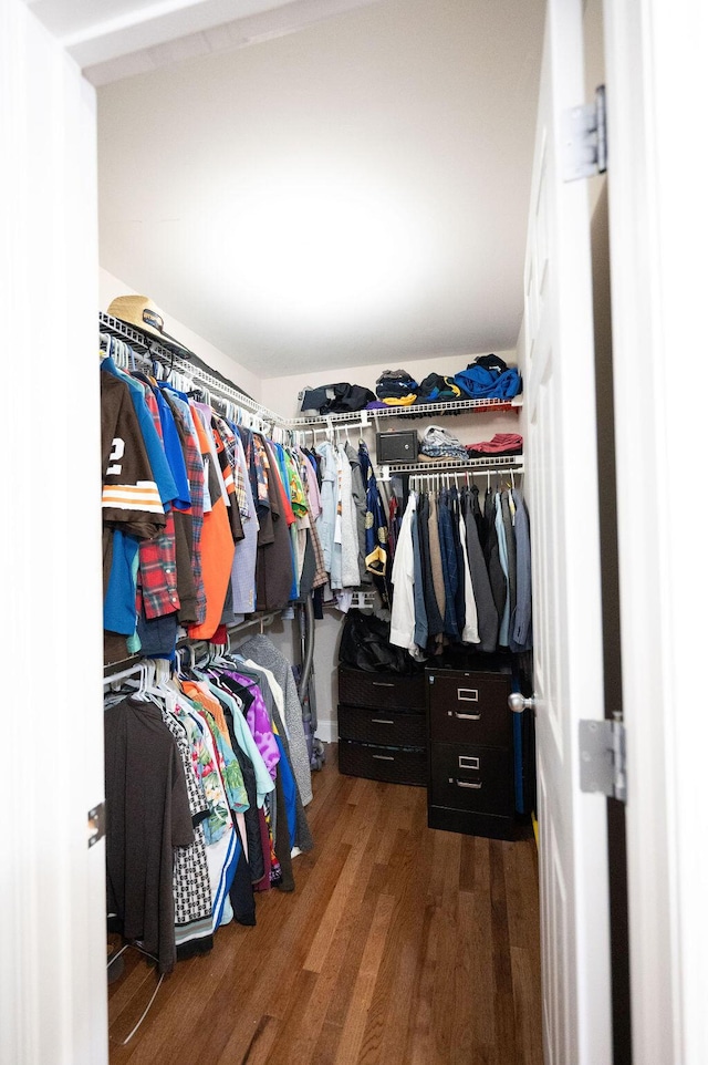 walk in closet with wood finished floors