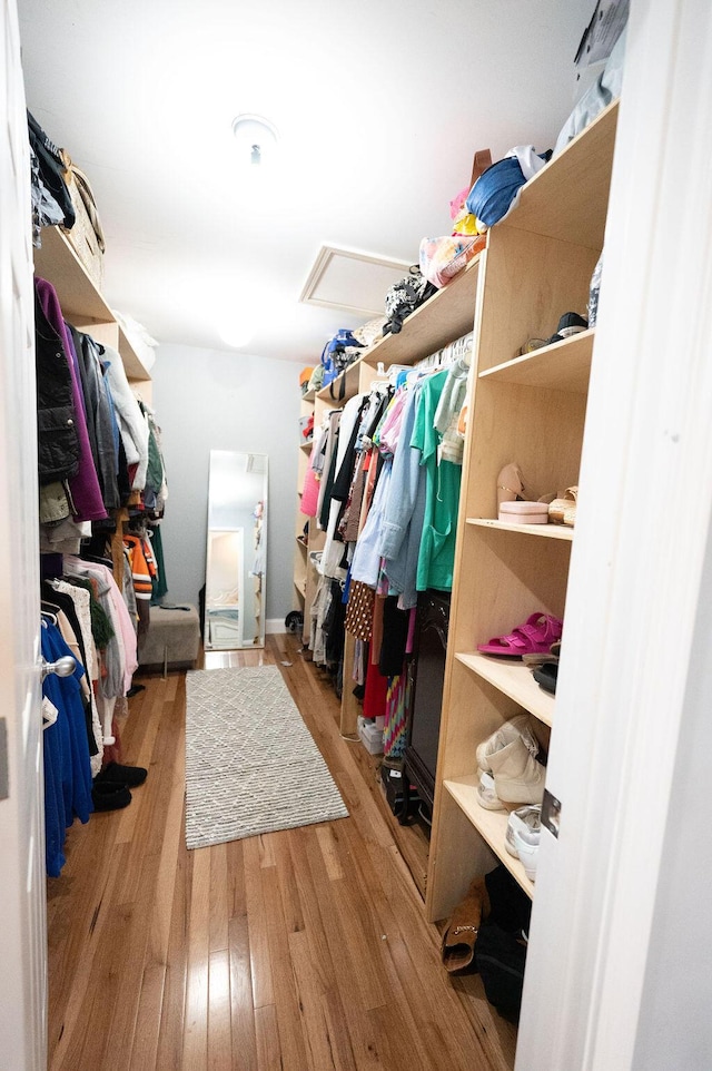 spacious closet featuring attic access and wood finished floors