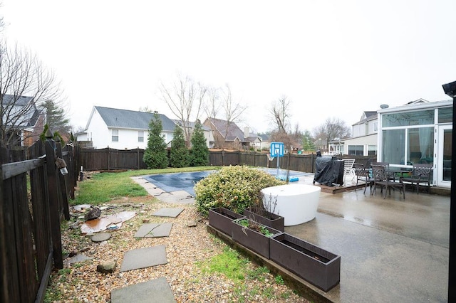 view of yard featuring a patio, a garden, a fenced backyard, and a fenced in pool