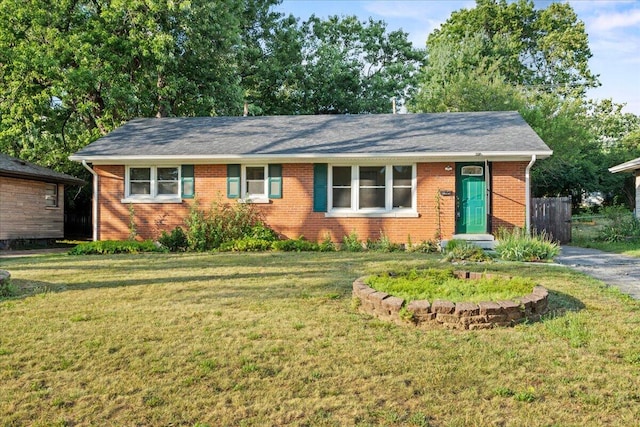 single story home featuring a front yard and brick siding