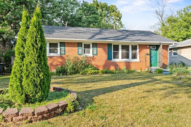 ranch-style house with brick siding and a front yard