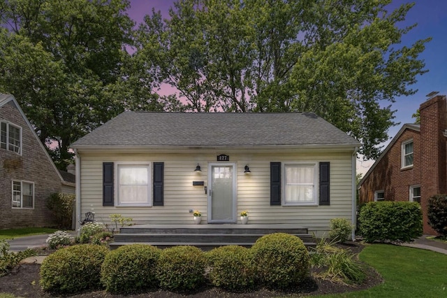 bungalow with a shingled roof